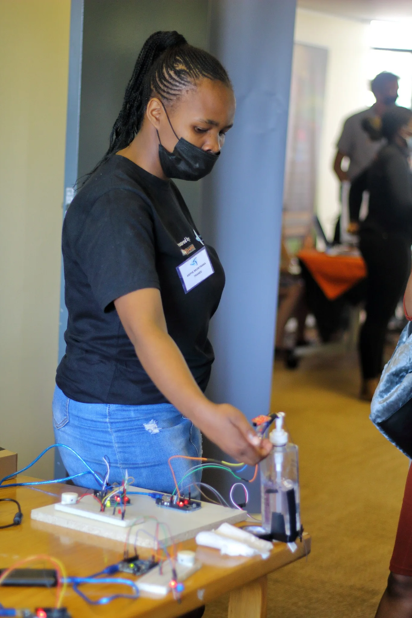 A learner working with wires and electronic components